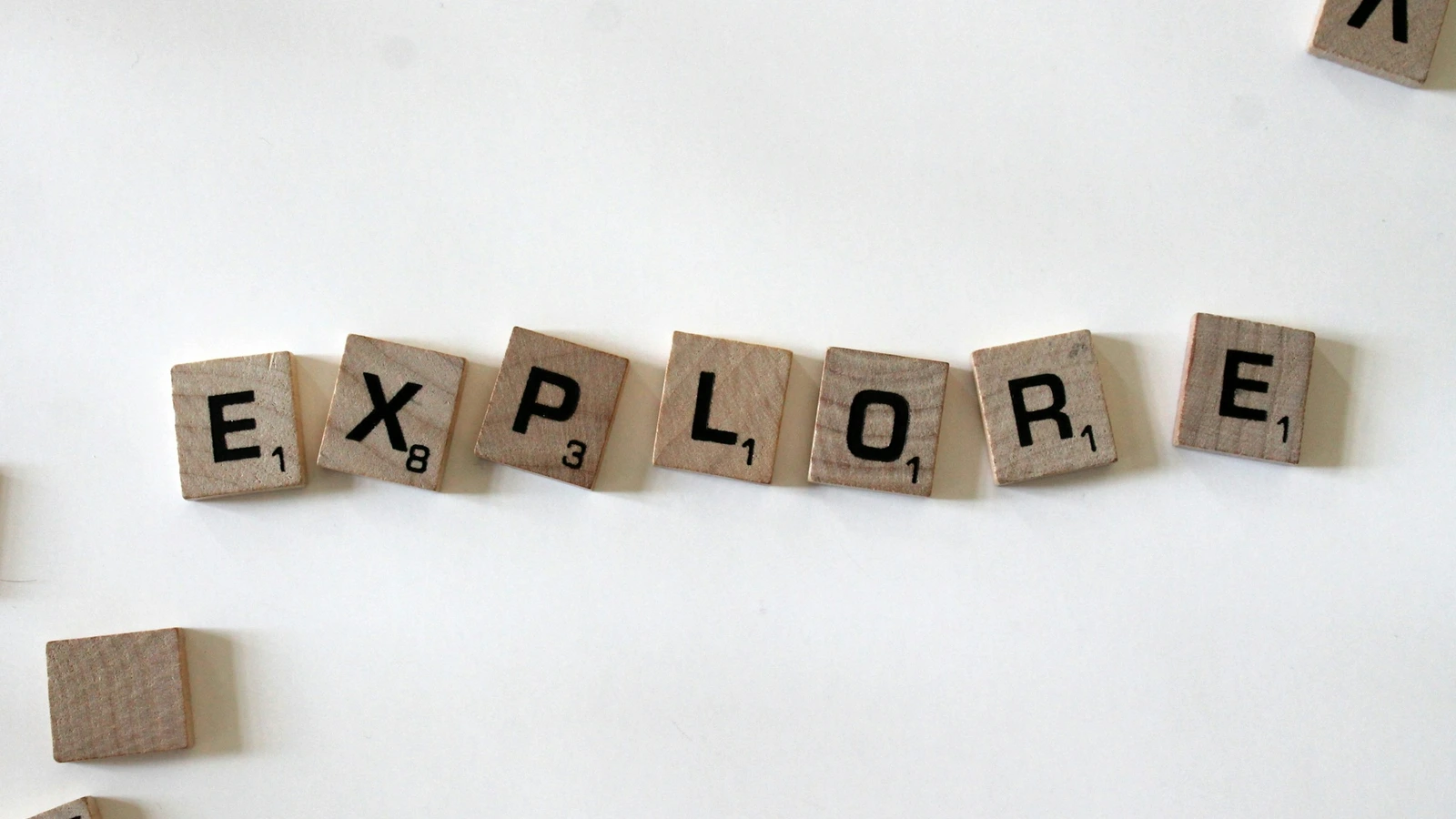 Flat lay photography of scrabble tiles forming the word explore — Photo by Amanda Jones on Unsplash