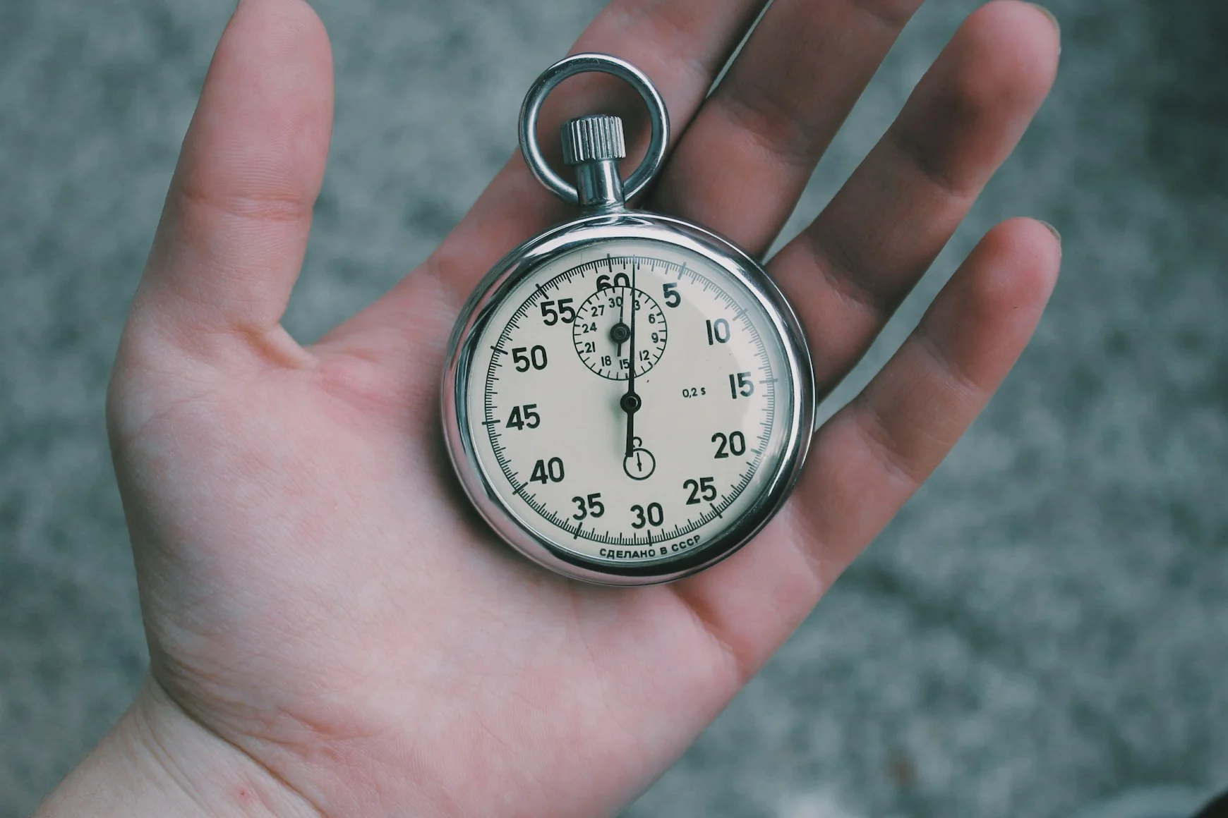 Person holding a silver pocket watch — Photo by Veri Ivanova on Unsplash
