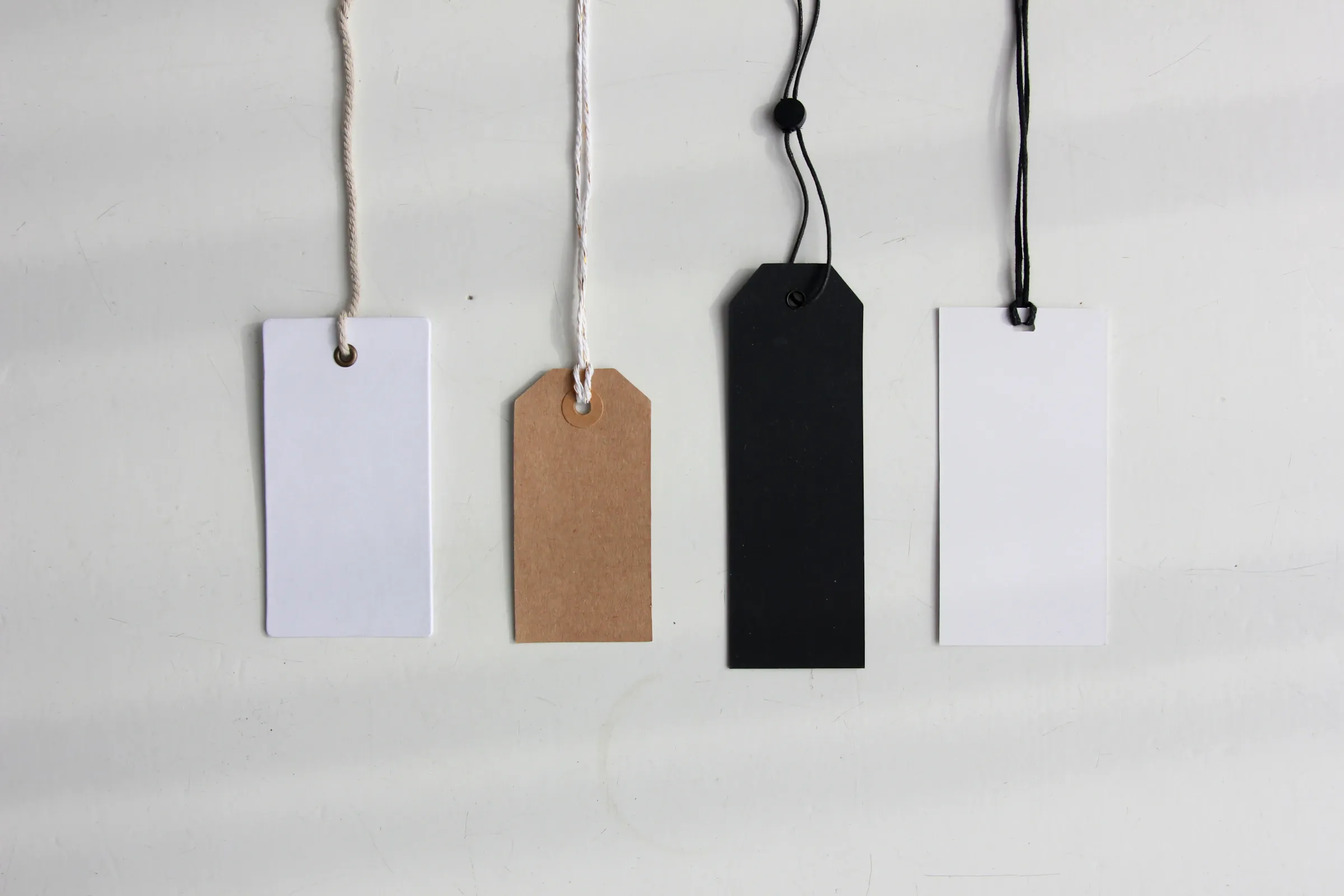 Four paper card tags on a dark background — Photo by Angèle Kamp on Unsplash